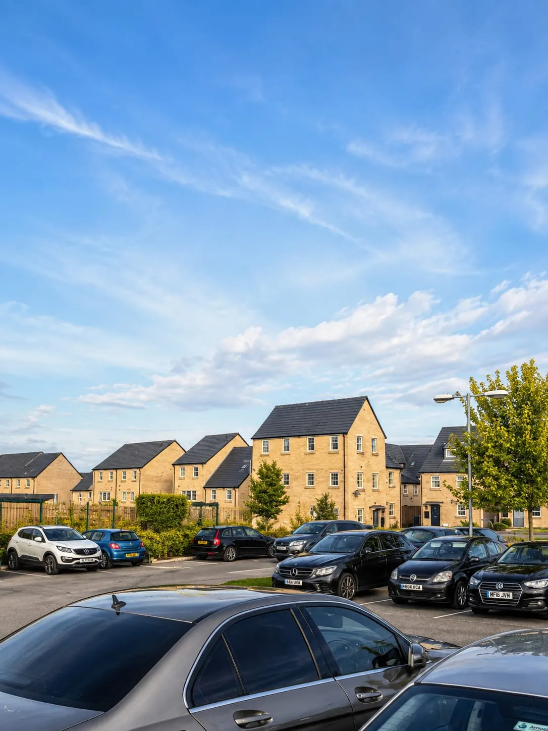 The car park at Northfield Hall, with rows of parked cars in front of the surrounding houses.
