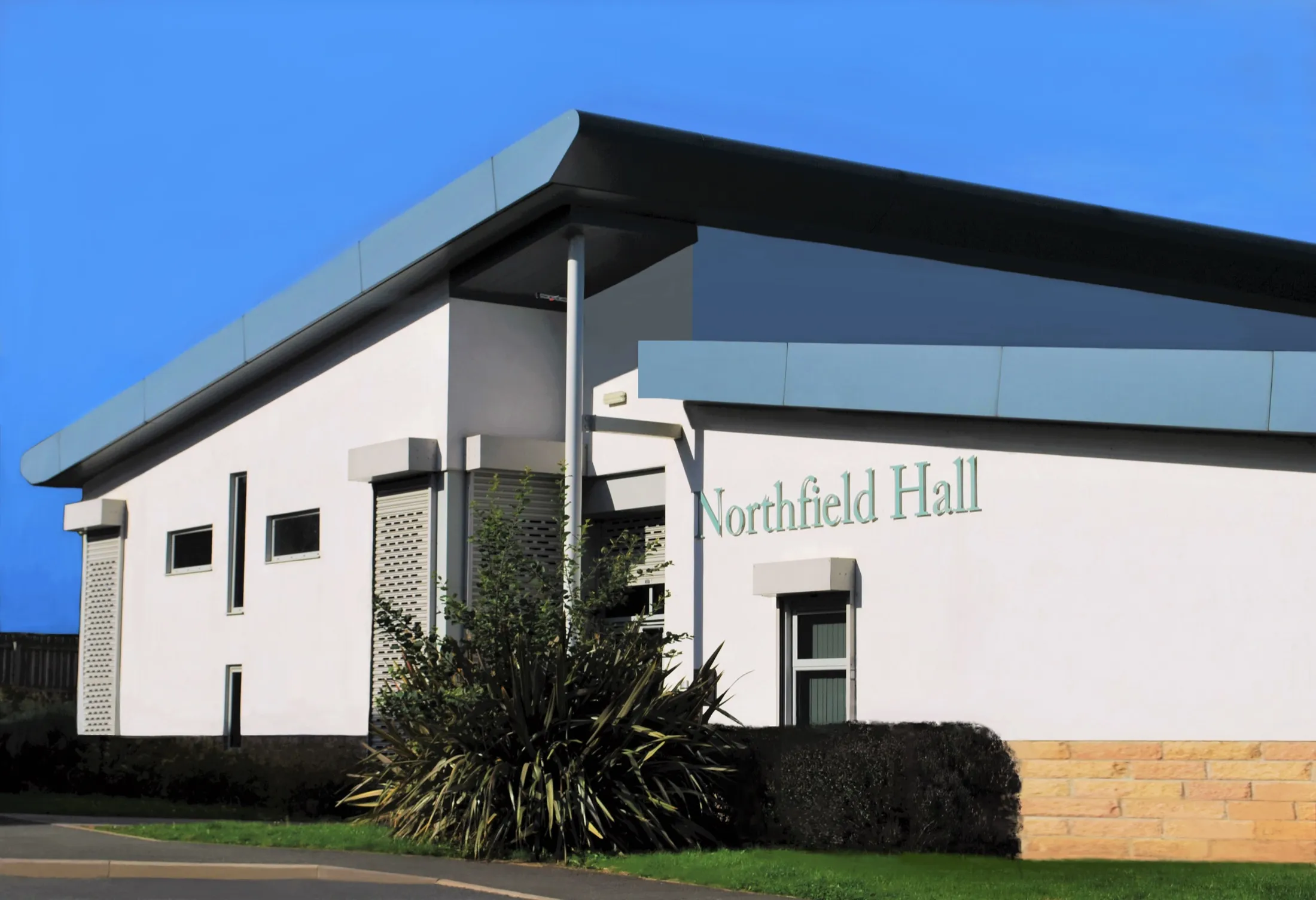 The outside of Northfield Hall on a sunny day, with the entrance canopy and the Northfield Hall sign on the wall.